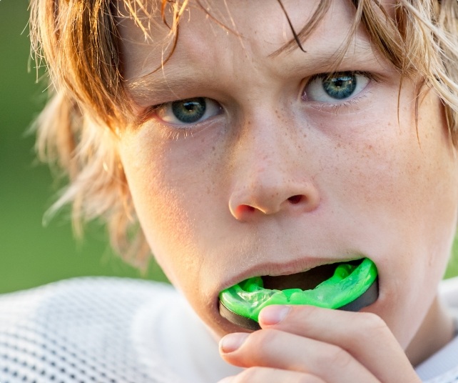 Teen placing an athletic mouthguard