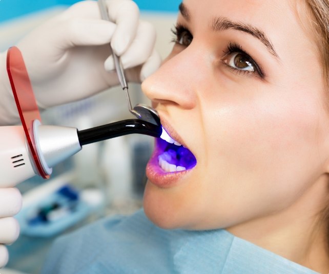 Dental patient receiving cosmetic dental bonding treatment