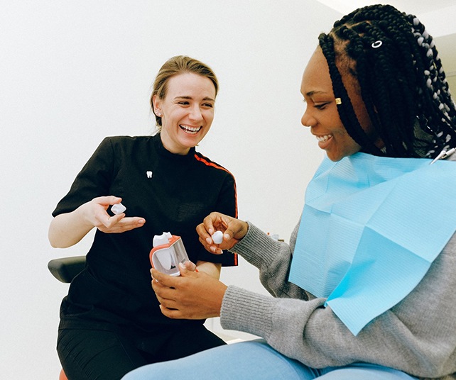 Dentist discussing dental crown with female patient