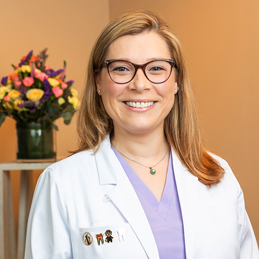 Woman smiling while visiting her dentist in Little Ferry New Jersey