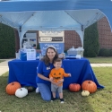 Dental team member and child at community event