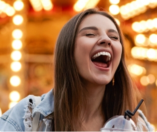 Woman laughing after replacing missing teeth