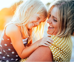 Mother and child smiling together after emergency dentistry