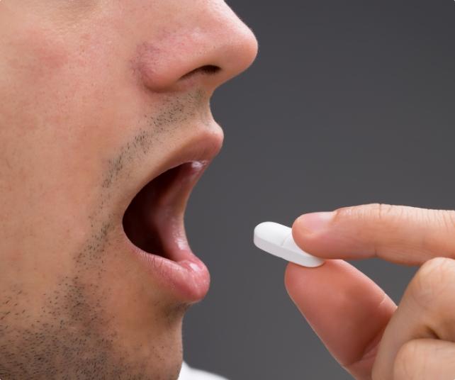 Dental patient taking oral conscious sedation dentistry pill