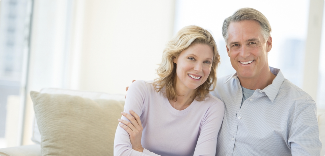 Man and woman smiling after receiving dental services in Little Ferry New Jersey