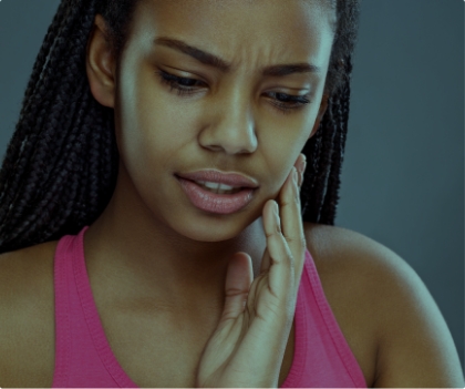 Woman holding jaw before T M J treatment