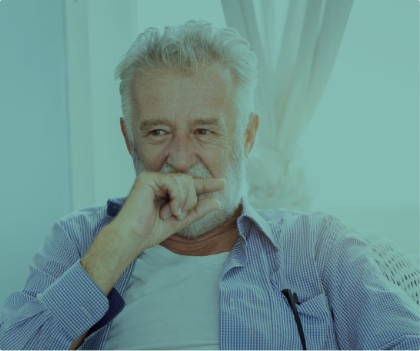 Man with missing teeth covering his smile