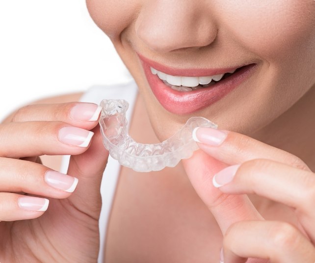 Closeup of dental patient placing an occlusal splint